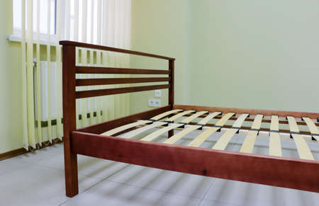 lacquered red wooden double bed with orthopedic slatsの写真素材