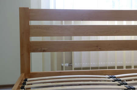 frame of a simple lacquered bed made of wood with slats without mattressの写真素材