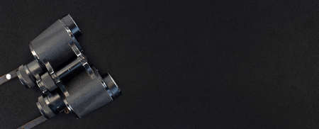 binoculars on black cloth, top view, place for textの写真素材