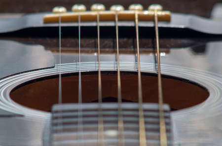 fretboard fragment with acoustic guitar strings, close-up, selective focusの写真素材