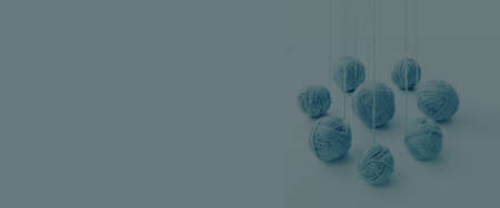 balls of blue yarn unwinding from a perspective, on an isolated white backgroundの写真素材