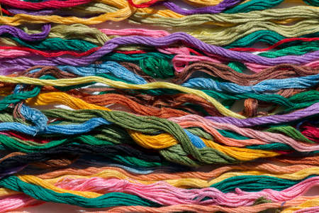 multi-colored threads for embroidery, floss, Mixed colorful texture of interlaced threadsの写真素材
