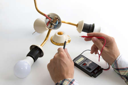 hands of the master repairing the disassembled chandelierの写真素材