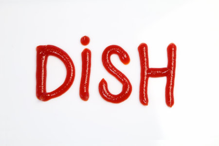 word dish drawn by ketchup on a white backgroundの写真素材