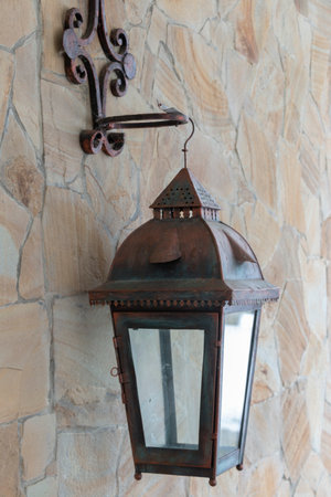 old bronze street lamp on the wallの写真素材