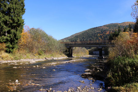 pedestrian bridge over a mountain river. Carpathians, Ukraineの写真素材