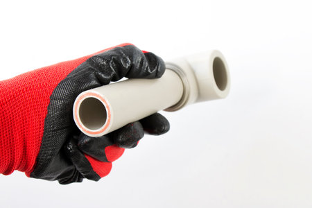 cut pvc pipe in the hand of the master, on an isolated whiteの写真素材