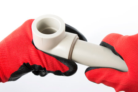 soldered pvc corner with a pipe in the master's handの写真素材