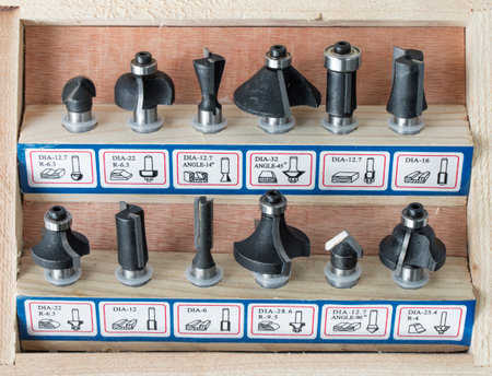 a set of milling cutters for processing wooden products with a joiner's hand power tool, on a white backgroundの写真素材