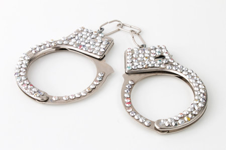 Handcuffs with jewelry, sex toy isolated on white backgroundの写真素材