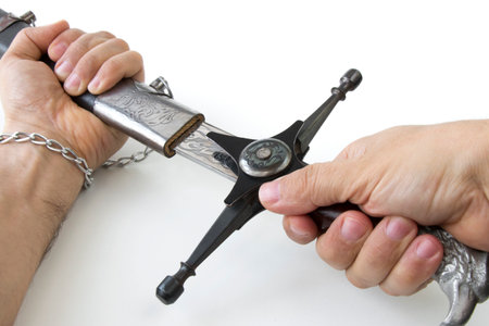 Ukrainian Cossack saber in the hands, gets out of the scabbard, close-up on a white backgroundの写真素材