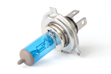 Halogen auto lamp, close-up of car headlight bulb isolated on white backgroundの写真素材