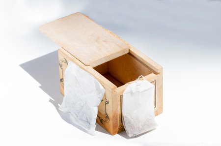 wooden box with tea bags, on a white backgroundの写真素材