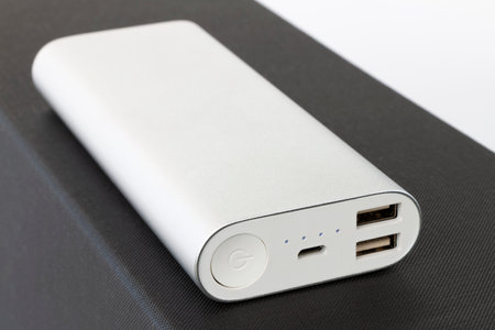 Silver aluminum power bank - black backgroundの写真素材