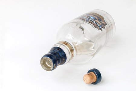 Dnipro, Ukraine - August 16, 2022: Empty open bottle of Chivas Regal 18yr Gold Signature Blended Scotch Whiskey, horizontally, on white backgroundのeditorial素材