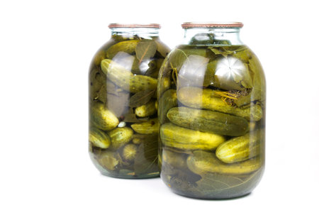 pickled cucumbers in a glass jar, on a white isolatedの写真素材