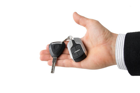 Businessman holding keys to electric motorcycle isolated on whiteの写真素材