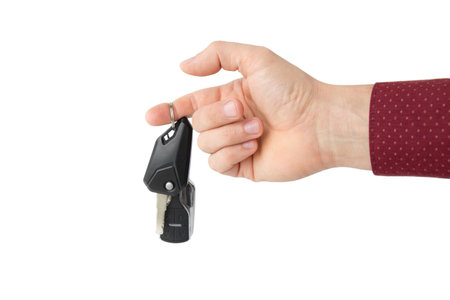 Hand with car key, isolated on whiteの写真素材