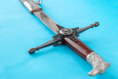 Cossack sword in a scabbard, close-up on a blue backgroundの写真素材