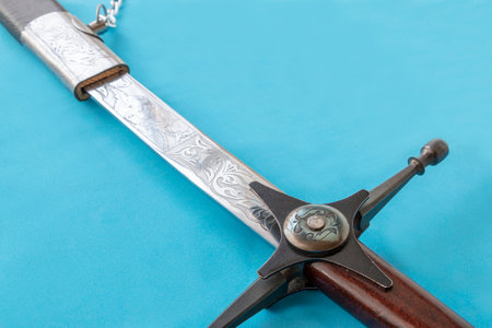 Cossack sword in a scabbard, close-up on a blue backgroundの写真素材