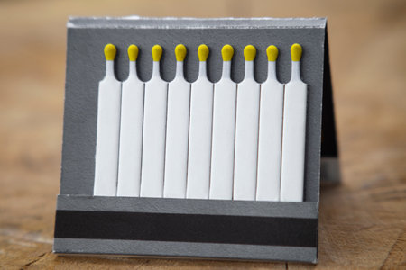 open box of matches and a whiskey flask, on a stump, close-up