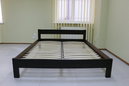 dark wooden double bed with hard backの写真素材