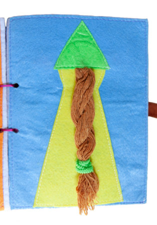 open sewn rag children's book, on a isolated backgroundの写真素材