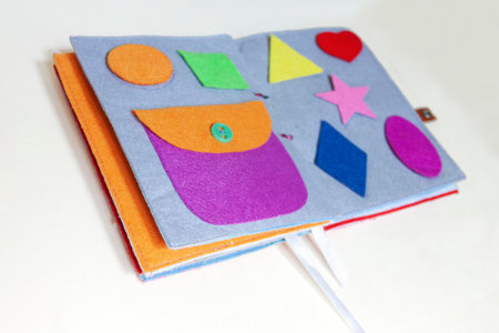 open sewn rag children's book, on a isolated backgroundの写真素材