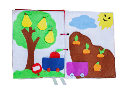 open sewn rag children's book, on a isolated backgroundの写真素材