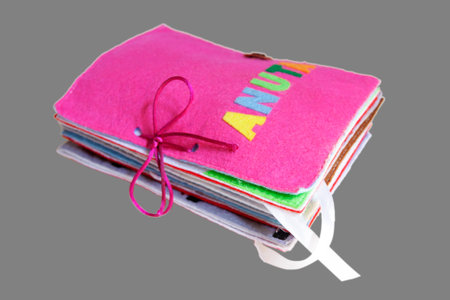 rag book for the development of children, on an isolated gray backgroundの写真素材