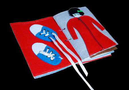 open sewn rag children's book, on a isolated backgroundの写真素材