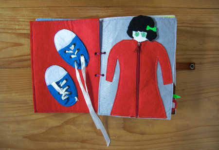 open sewn rag children's book, on a isolated white backgroundの写真素材