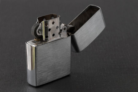 Windproof petrol lighter in metal style, on a dark textured backgroundの写真素材