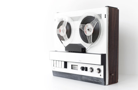 old-style reel-to-reel tape recorder, selective focus, close-up on a white backgroundの写真素材