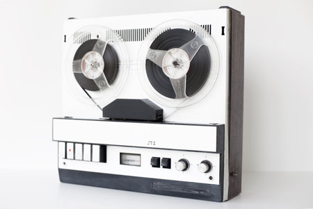 old-style reel-to-reel tape recorder, selective focus, close-up on a white backgroundの写真素材
