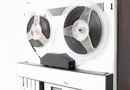 old-style reel-to-reel tape recorder, selective focus, close-up on a white backgroundの写真素材