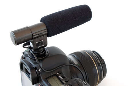 a gun microphone mounted on a camera, on a white isolated backgroundの写真素材