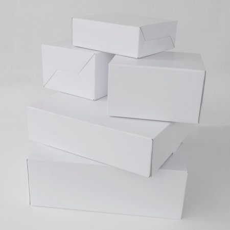 closed white cardboard boxes on the tableの写真素材