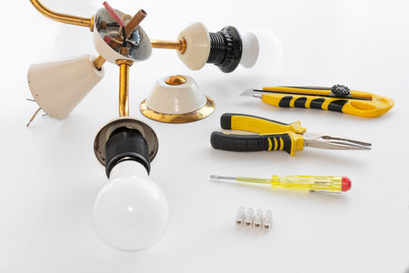 disassembled old chandelier and tool on white backgroundの写真素材