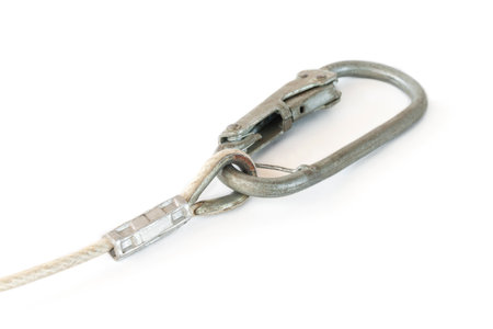 metal carabiner with a rope, on an isolated white backgroundの写真素材
