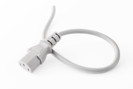 a cut cable with a network plug connector for connecting a computer to an uninterruptible power supply, on a white backgroundの写真素材
