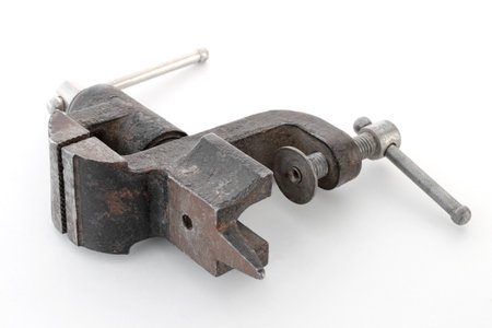 Close-up of vise with screw handle on isolated white backgroundの写真素材