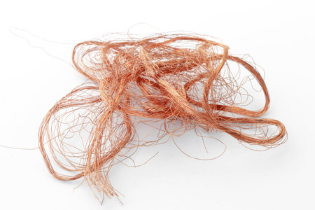 tangled copper strands of a network wire, on a white backgroundの写真素材