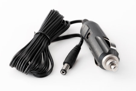 Car battery charger for mobile phones, laptops, isolated on white backgroundの写真素材
