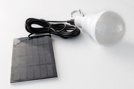 Autonomous rechargeable light bulb with solar panel, on a white backgroundの写真素材