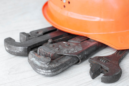 plumbing tool, gas wrenches and work helmet, close-upの写真素材