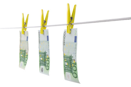 euro paper money dries on a rope, on a white isolated backgroundの写真素材