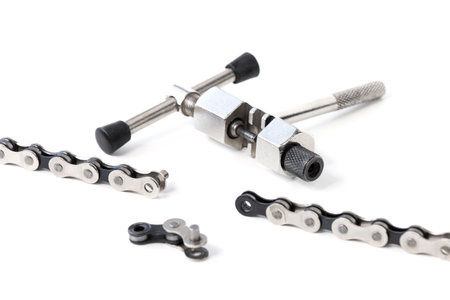 dismantled bicycle chain, chain link puller, tool, on a white isolated backgroundの写真素材