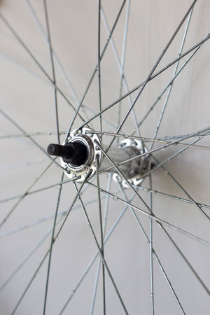 element of a bicycle aluminum rim with spokes and a sleeve, with raindrops, close-upの写真素材