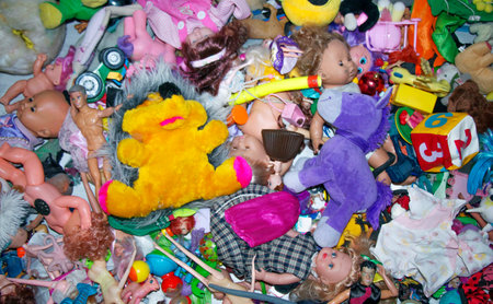 a lot of children's toys dumped in a pile, scattered dollsの写真素材